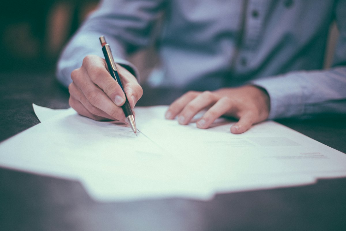Person reviewing documents and records at a desk
