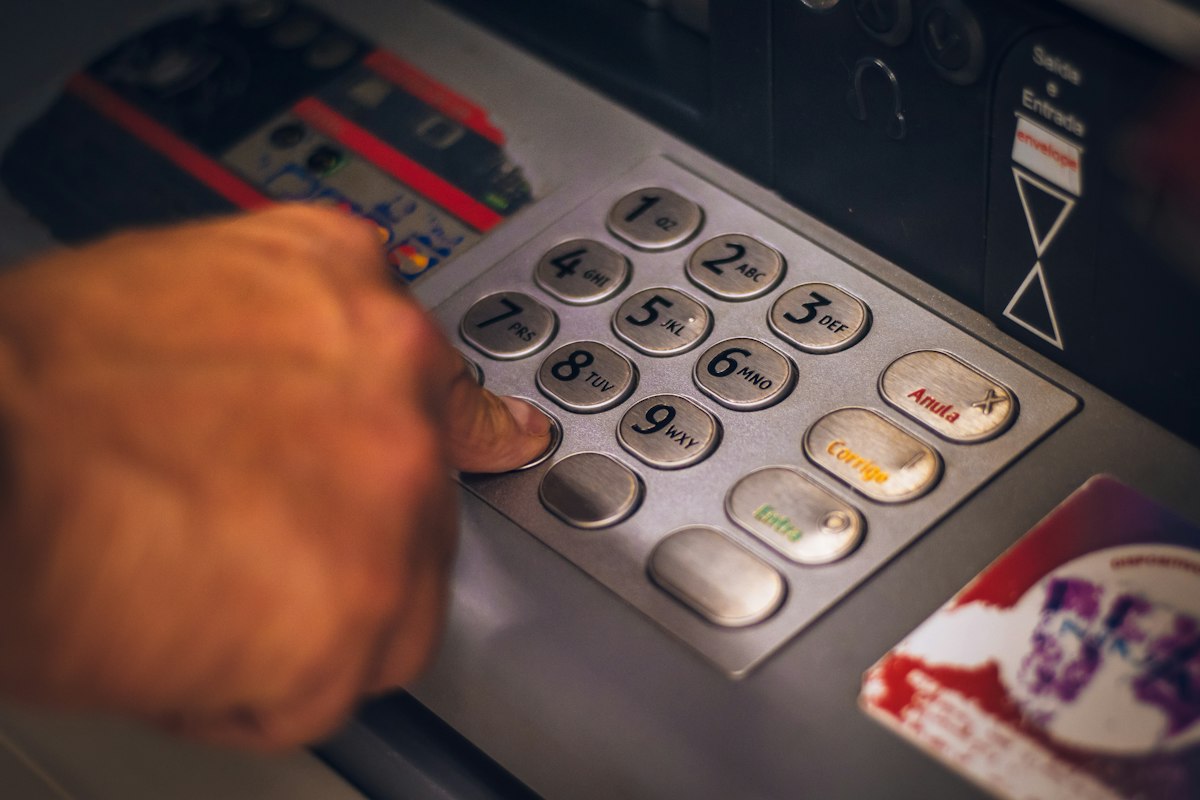 Close-up of a hand holding a smartphone showing a mobile money payment screen