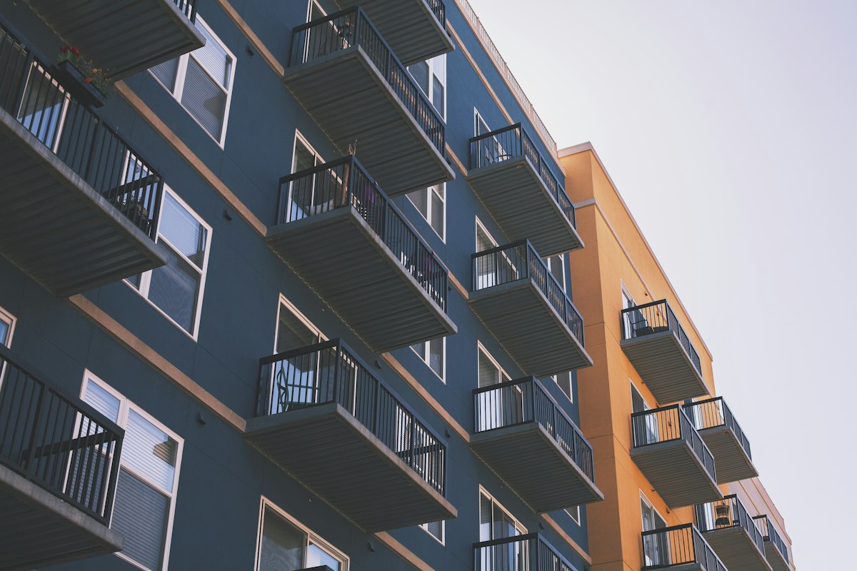 Property manager walking through a mid-sized apartment complex checking units
