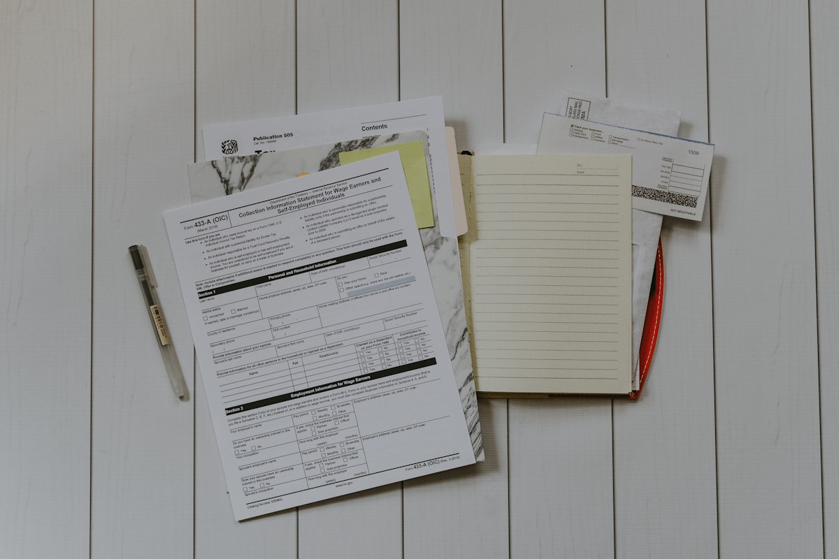 Close-up of a person reviewing printed financial documents and receipts at a desk