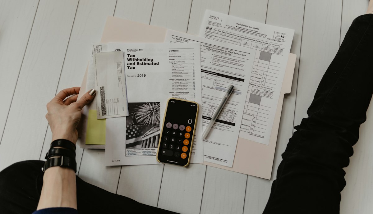 Landlord and tenant reviewing a lease document together at a table