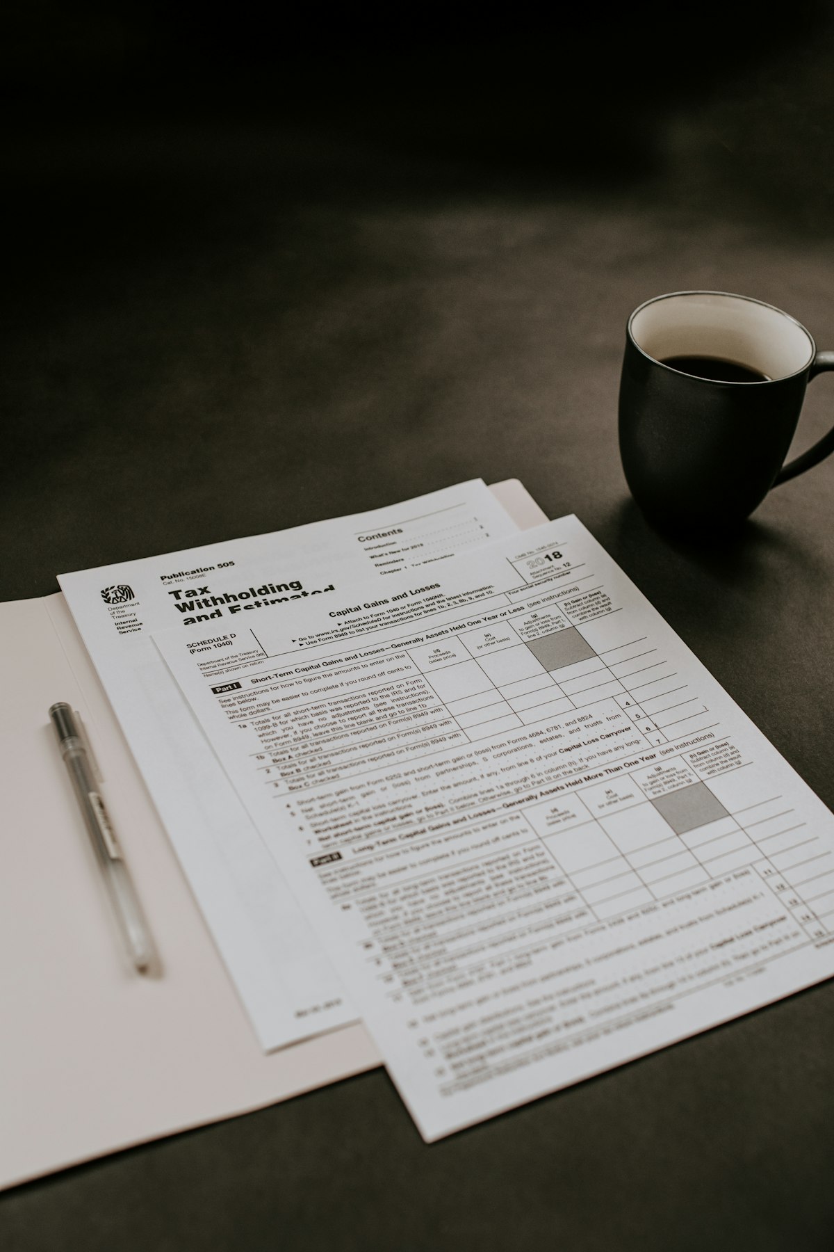 A pile of paper receipts and invoices scattered next to a calculator on a desk
